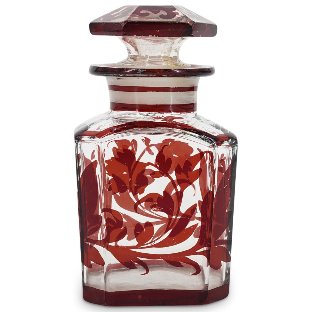 Bohemian Red Glass Tea Caddy: DESCRIPTION: A Bohemian glass tea caddy with red enamel foliate decorations. CIRCA: 19th Cent. ORIGIN: Czech DIMENSIONS: H: 6.25" x D: 3.5" CONDITION: Scratching and flea bite at underside, chipping t