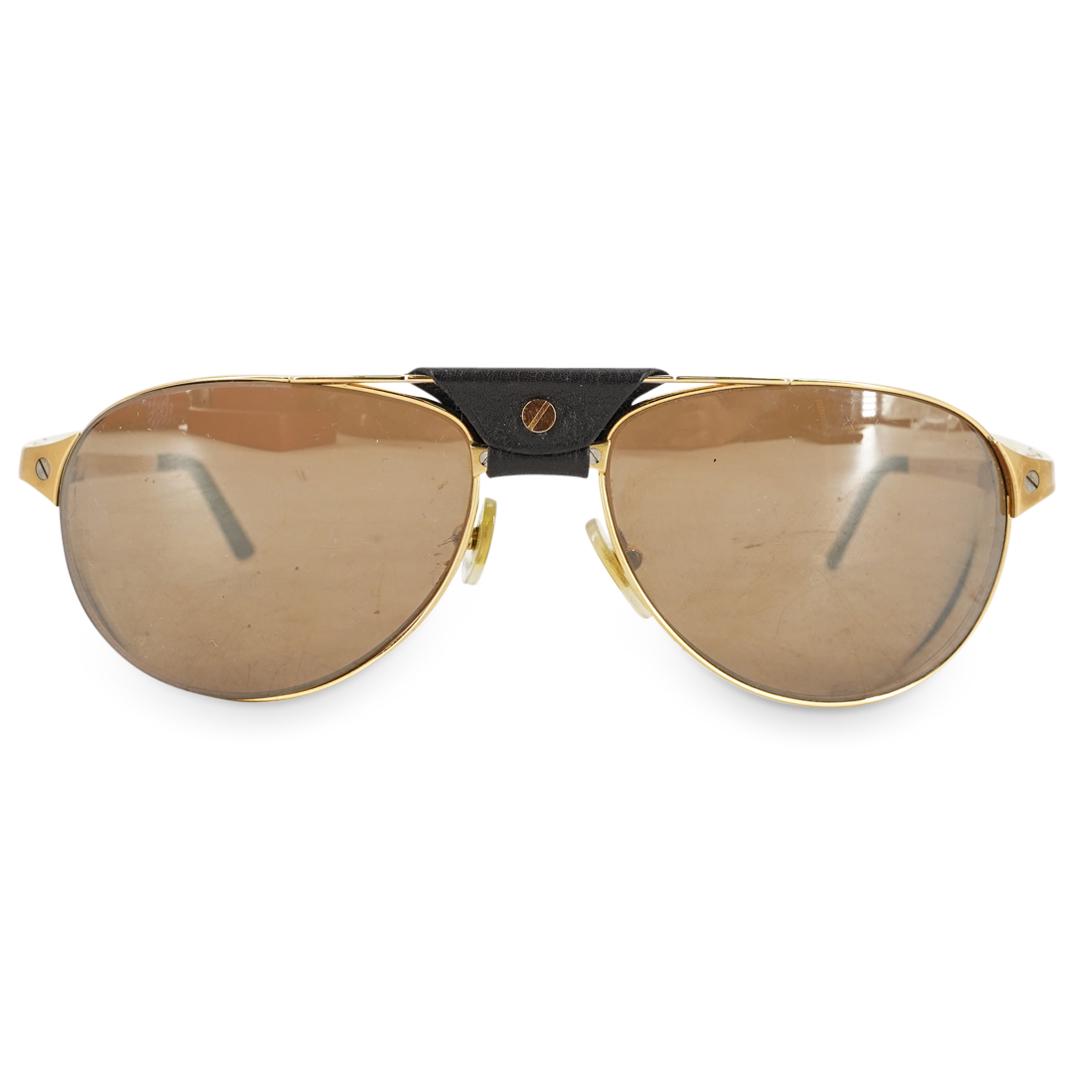 Vintage Must de Cartier Gold Plated Eyeglasses: DESCRIPTION: A Vintage Must de Cartier gold plated eyeglasses with prescription lenses. Marked "Cartier", and "Made in France". With original Cartier case. CIRCA: 20th Century ORIGIN: France. DIMENSIO