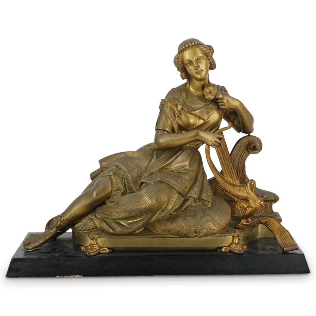 Orientalist Bronze Sculpture Of Reclining Woman With Harp: DESCRIPTION: Orientalist bronze sculpture of a woman with a flower reclining on a pillow and leaning on a scroll form structure. Woman is adorned with flowing garments and a headband and reclines adja