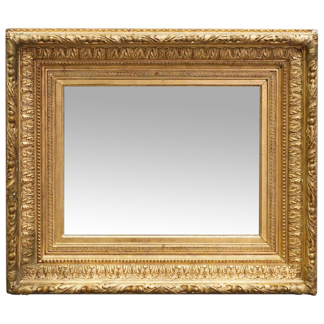 Antique French Giltwood Mirror: DESCRIPTION: Antique French mirror mounted in gilt gessoed wood frame featuring foliage in high relief throughout. CIRCA: 19th Century possibly older ORIGIN: France DIMENSIONS: H: 26.75" X W: 31.5" X 