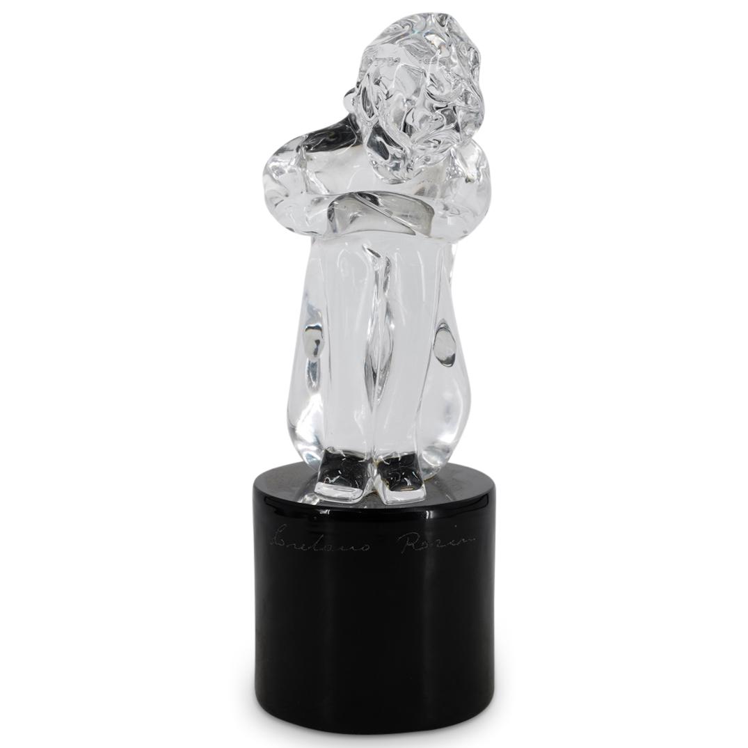 Loredano Rosin (Italian, 1936-1991) "Crouching Nude" Glass Sculpture: DESCRIPTION: Clear Murano glass sculpture by Italian artist Loredano Rosin (1936-1991) titled "Crouching Nude"; Depicting a crouched nude woman atop a circular black glass pillar. Signature etched at 