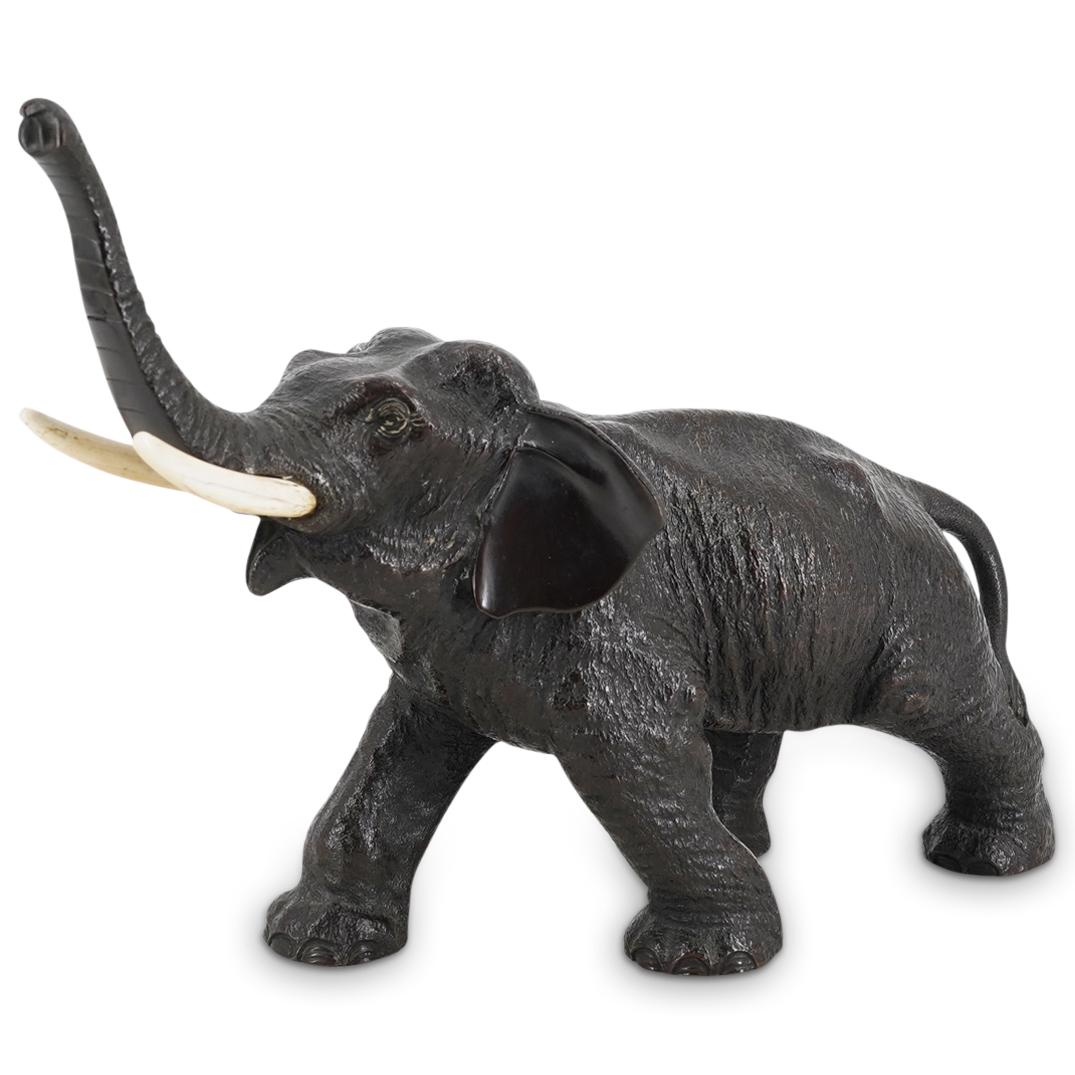 Japanese Meiji Bronze Elephant: DESCRIPTION: An antique Japanese Meiji period bronze elephant with patinated finish and bone tusks. Character markings at underside. CIRCA: Late 19th - Early 20th Cent. ORIGIN: Japan DIMENSIONS: H: 9"