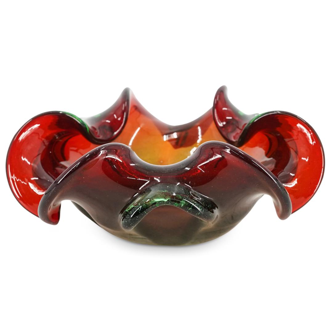 Murano Glass Handkerchief Bowl: DESCRIPTION: Murano glass handkerchief bowl comprised of graduating red and orange hues throughout, green handles and handkerchief folds around the rim. CIRCA: 20th Century ORIGIN: Italy DIMENSIONS: H