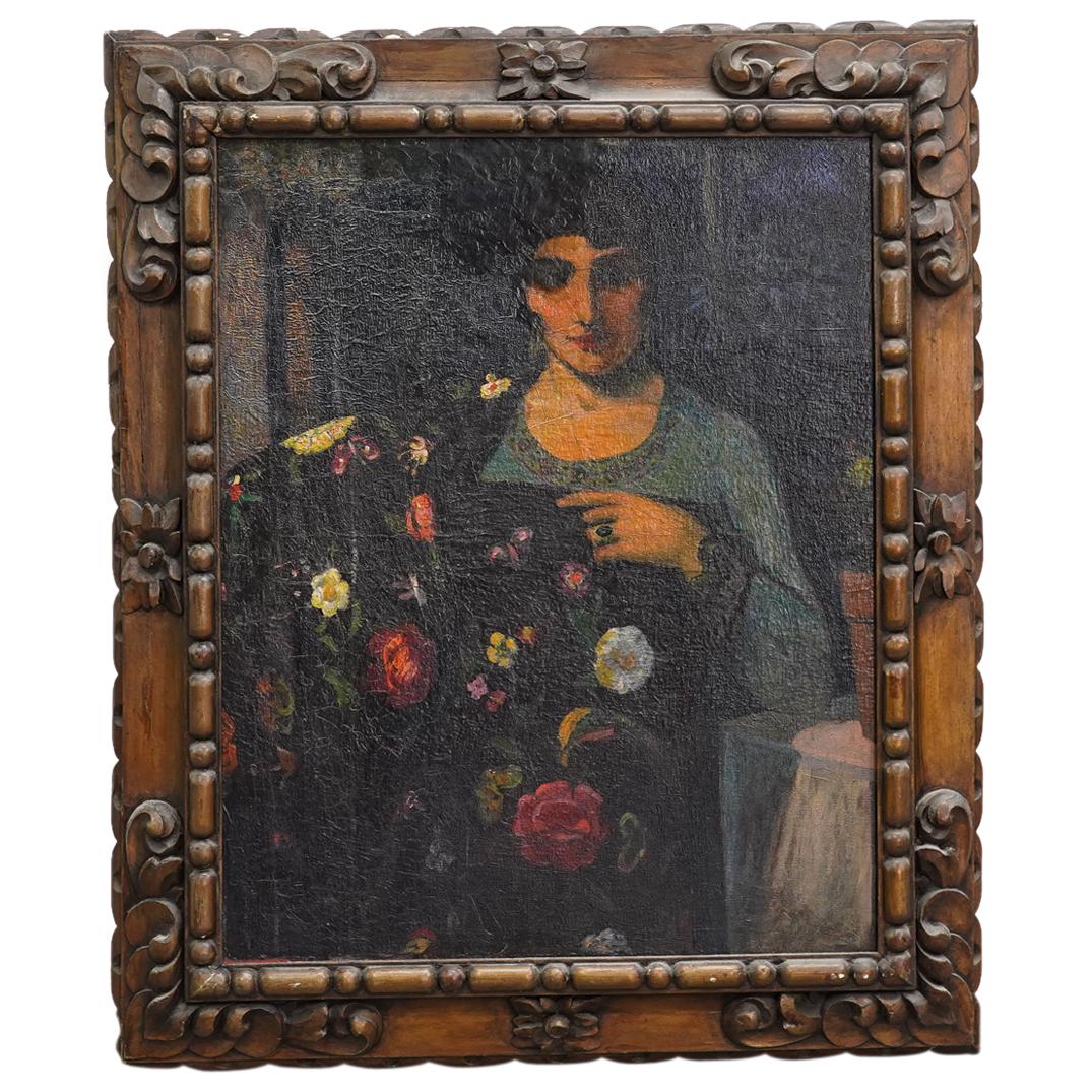 Antique Spanish School Portrait Oil on Canvas: DESCRIPTION: Antique spanish school oil on canvas portrait of a woman holding a article of black clothing with floral designs. Signed lower left "Eduaruo Suay". Mounted in carved dark wood frame with 