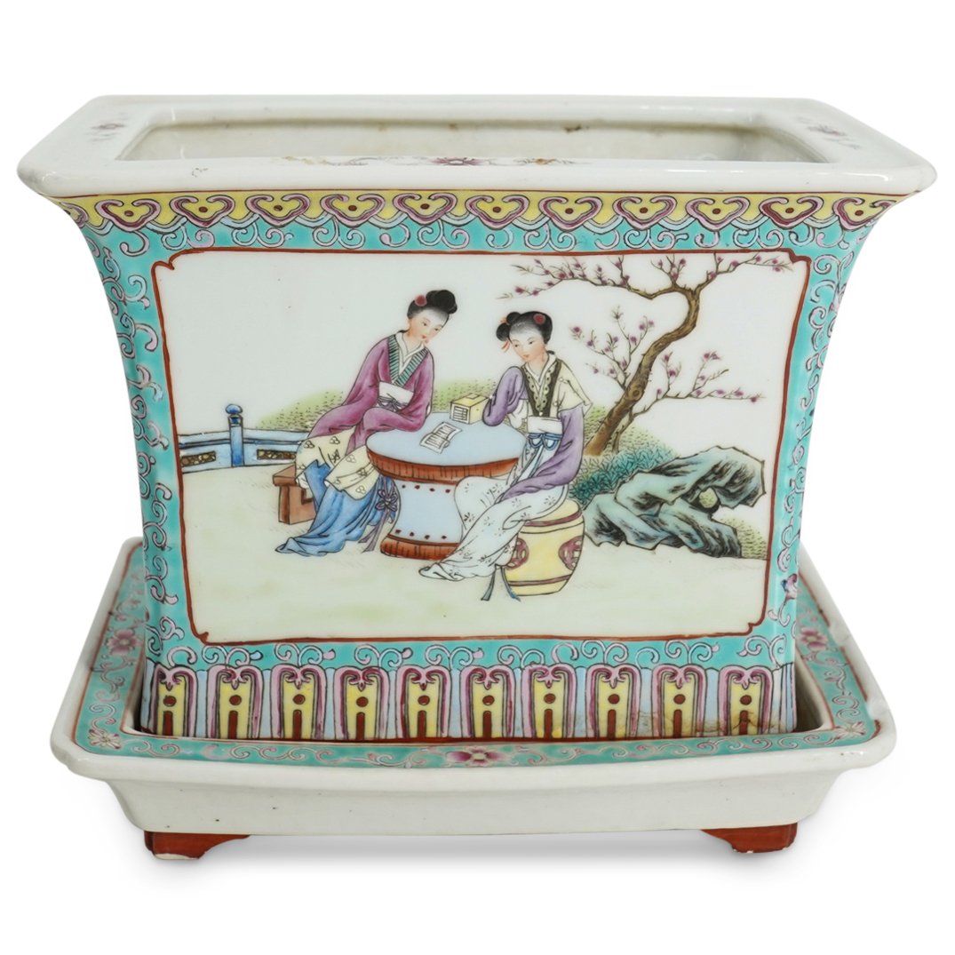 Chinese Republic Court Ladies Porcelain Jardiniere: DESCRIPTION: Antique famille rose porcelain jardiniere decorated with two scenes of court ladies reading at a table in a garden and embellished with floral and foliage motifs and lingzhi (ganoderma mu