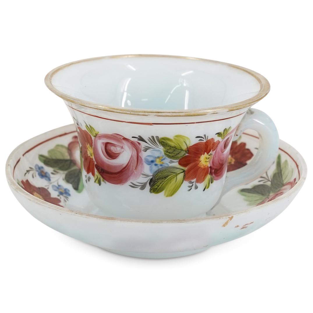 (2 Pc) Turkish Beykoz Opaline Teacup And Saucer: DESCRIPTION: Beykoz opaline glass teacup and saucer, each decorated with a gilt accent on the rim. Teacup is embellished with floral and foliage motifs on the outside and saucer is embellished with fl