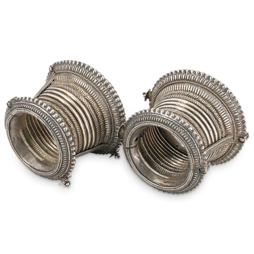 Pair of Afghan Silver Cuffs: DESCRIPTION: Pair of Afghan silver cuffs with bead and ribbed designs. CIRCA: 19th Cent. ORIGIN: Afghanistan DIMENSIONS: H: 3.5" x D: 4.5" (Total Weight: 320 Grams) CONDITION: Great condition. See lot