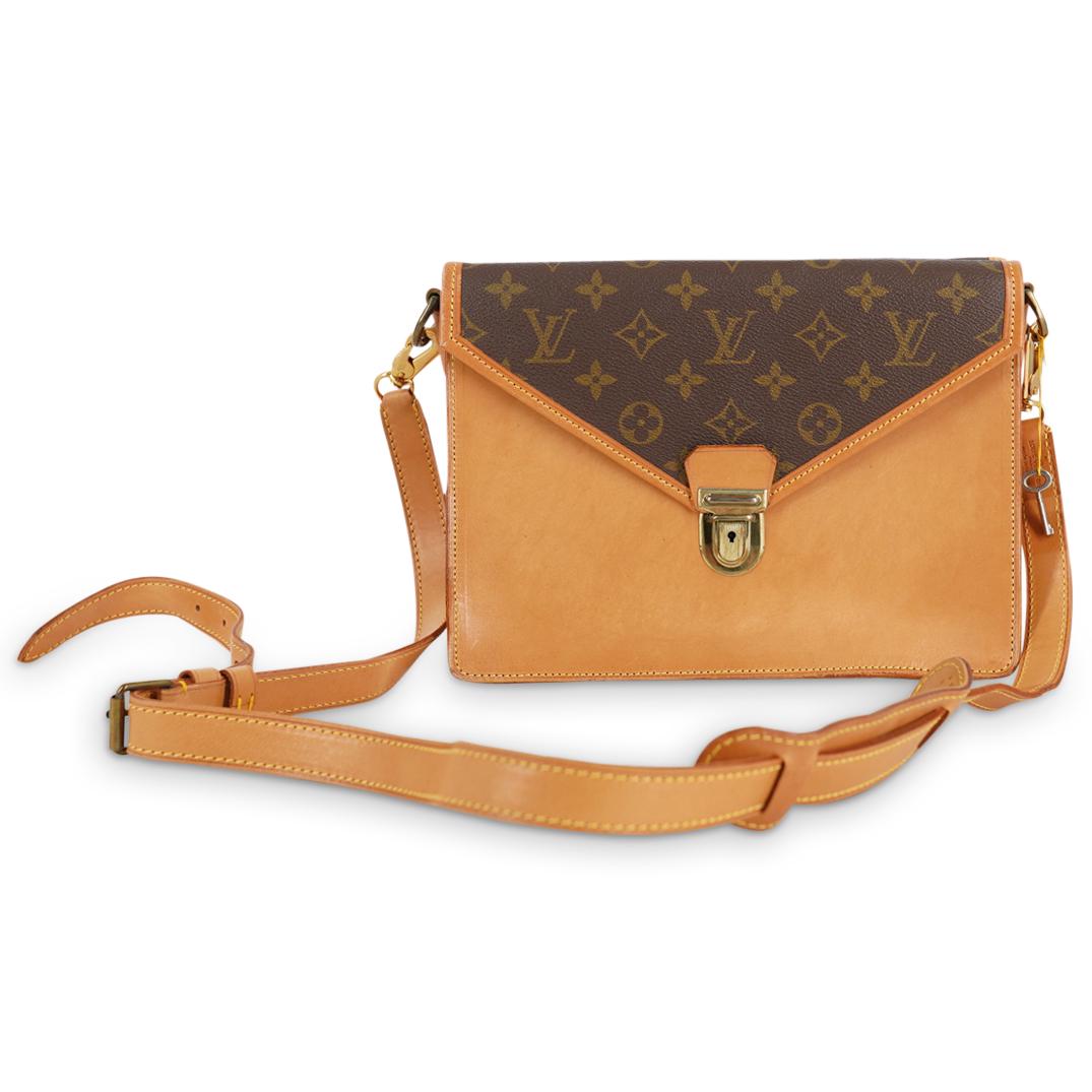 Vintage Louis Vuitton Sac Biface Monogrammed Satchel: DESCRIPTION: A Vintage louis vuitton sac biface satchel features two monogrammed leather flap openings, with brass hardware, and zipper storage compartment. Attached to an adjustable strap. Stamped al