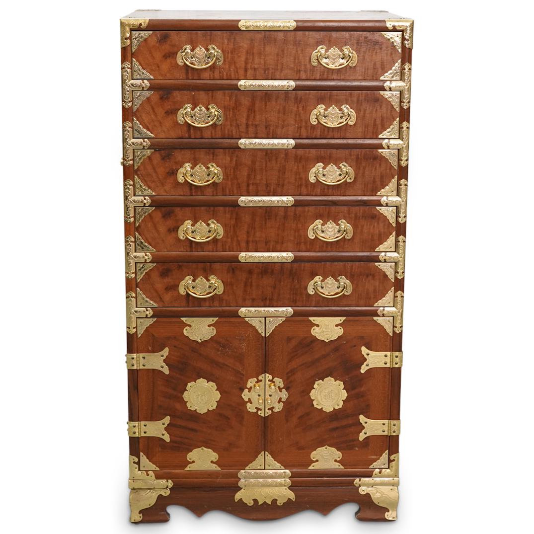 Chinese Wooden Cabinet With Gilt Trimmings: DESCRIPTION: Wooden five drawer, two door cabinet featuring gilt bat, floral, and foliage design trimmings throughout. Central foliage design on each door is embellished with a Han character, and hand