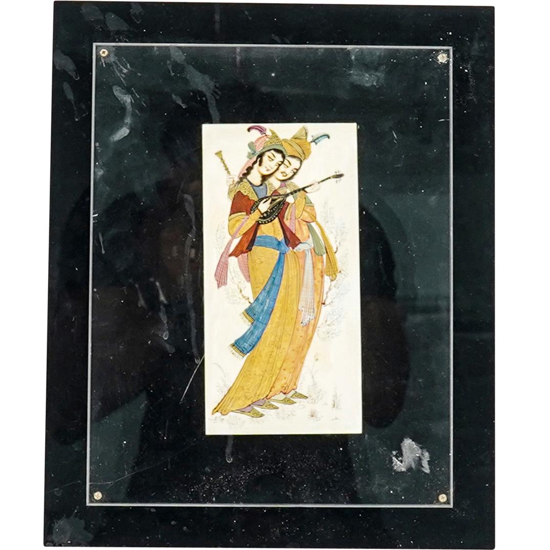 Signed Antique Persian Painting On Bone Of Couple: DESCRIPTION: Painting on bone depicting a man holding vessels and a woman playing a lute, both surrounded by foliage motifs. Piece is signed at bottom left in Farsi and adhered to a black frame with a