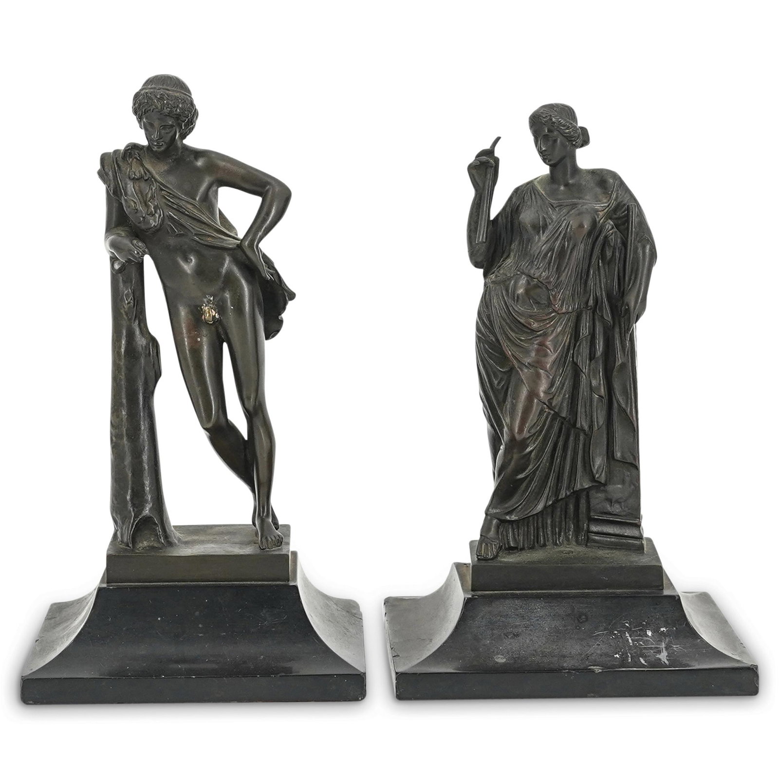 (2 Pc) 19th Century Grand Tour Bronze Sculptures: DESCRIPTION: Pair of neoclassical bronze sculptures-one of a nude man leaning against a tree, one of a woman leaning against a pillar. Each piece is mounted on a black stone base. Dimensions are as fo