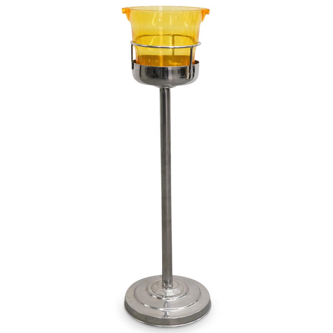 Vintage Composite Wine Cooler With Metal Stand: DESCRIPTION: Vintage wine cooler featuring a yellow, transparent, composite bucket inset atop a silver tone stand with a gallery railing and a round foot. CIRCA: 20th Century ORIGIN: Continental DIMEN