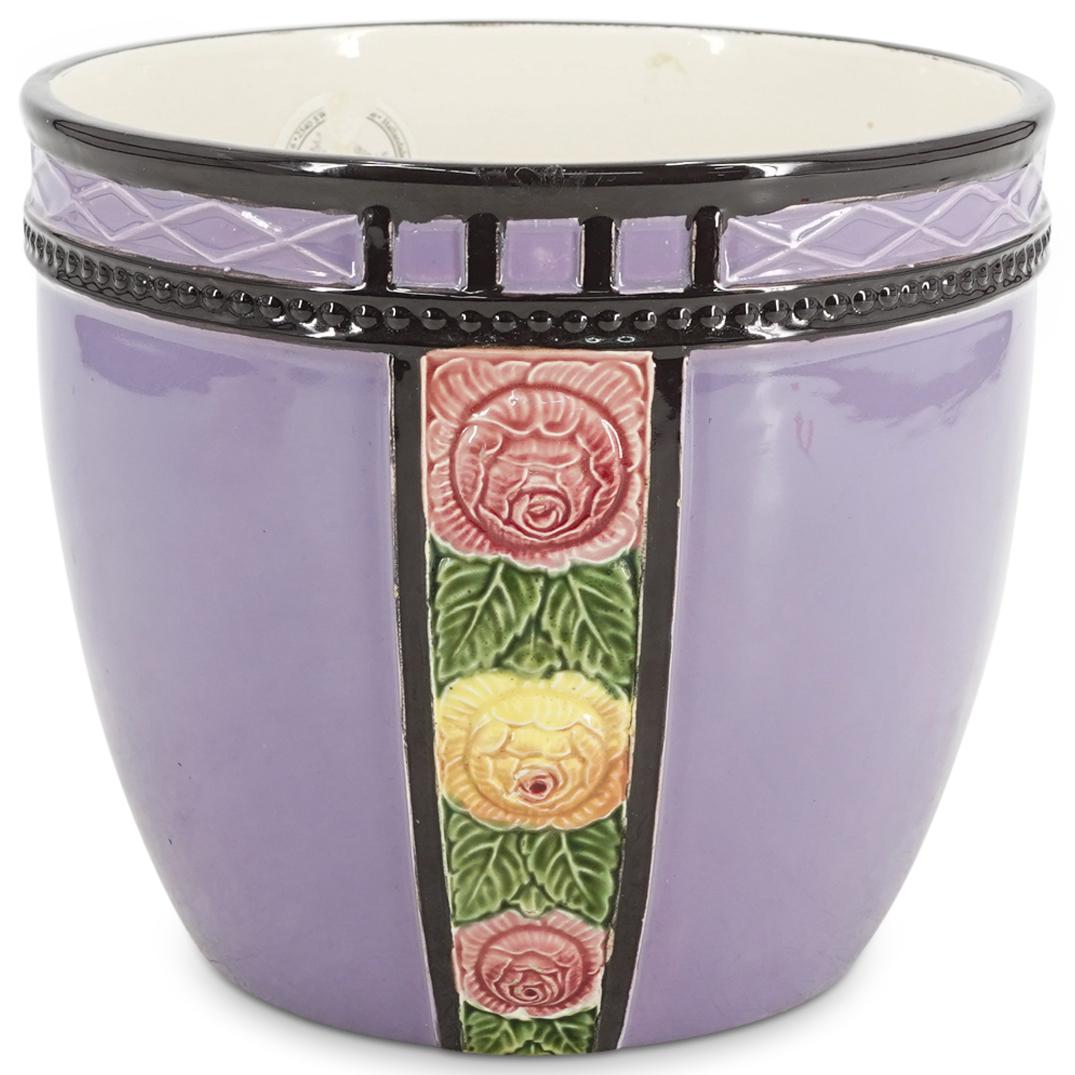 Antique Eichwald Czech Majolica Jardiniere: DESCRIPTION: Antique Eichwald Czech ceramic pottery jardiniere with majolica glaze finish presenting a lavender tone throughout and bands at the sides with depictions of pink and yellow roses in relie