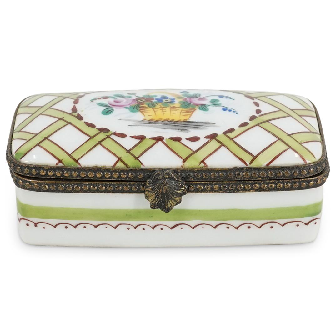 Limoges Porcelain Rectangular Pill Trinket Box: DESCRIPTION: A Limoges porcelain rectangular pill trinket box, in white porcelain and further embellished with a weaved basket motif and central basket with a polychrome bouquet of flowers. Marked on 