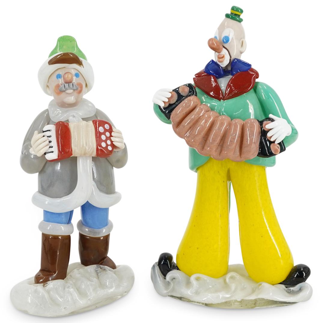 (2Pc) Zelezny Brod Czech Glass Accordion Figurines: DESCRIPTION: (2Pc) Zelezny Brod Czech glass sculptures of figurines playing accordions with colorful details throughout. Includes: A man in winter attire composed of a white base, brown boots, blue pa