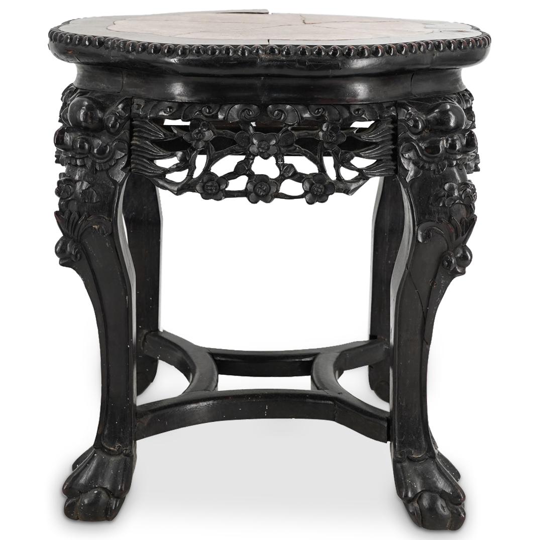 Chinese Carved Wood Marble Top Table: DESCRIPTION: Carved wooden table fashioned via joinery and featuring a marble inset top. Piece is decorated with floral and foliage designs at he skirt, toatie faces at the tops of the legs, and ball 