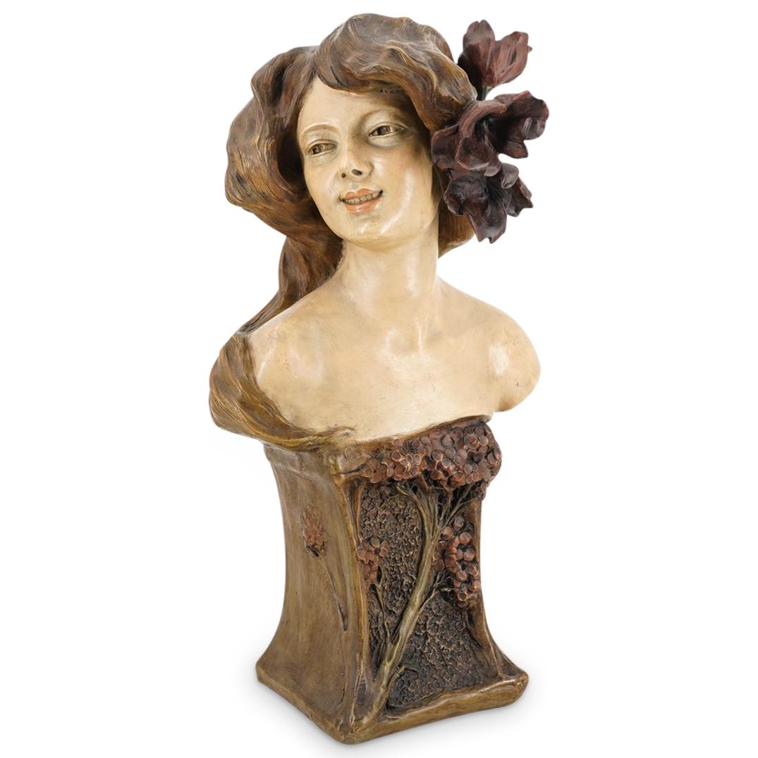 Terracotta Art Nouveau Woman's Bust In Style Of Alfred Jean Foretay: DESCRIPTION: Terracotta sculpture in the style of Alfred Jean Foretay depicting a woman's bust atop a plinth decorated with a floral and foliage design in relief. Woman is smiling and is embellished w