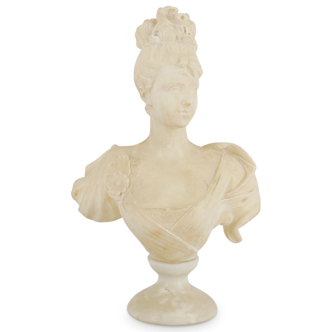 Antique Carved Alabaster Woman's Bust Sculpture: DESCRIPTION: Carved alabaster bust of a woman wearing elegant garments and a floral brooch and posing to her left. Piece is mounted on a circular plinth. CIRCA: 20th Century DIMENSIONS: H: 17" W: 6.5"