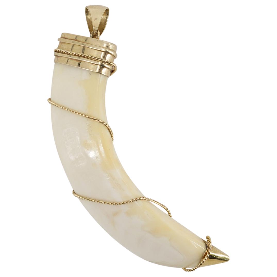 18k Gold Boar Tusk Pendant: DESCRIPTION: Boar tusk pendant comprised of a 18k gold cap with a loop, gold ferrule and gold wire wrapped around the tusk. CIRCA: 20th Century ORIGIN: Continental DIMENSIONS: W: .84" L: 3.75" Have a 