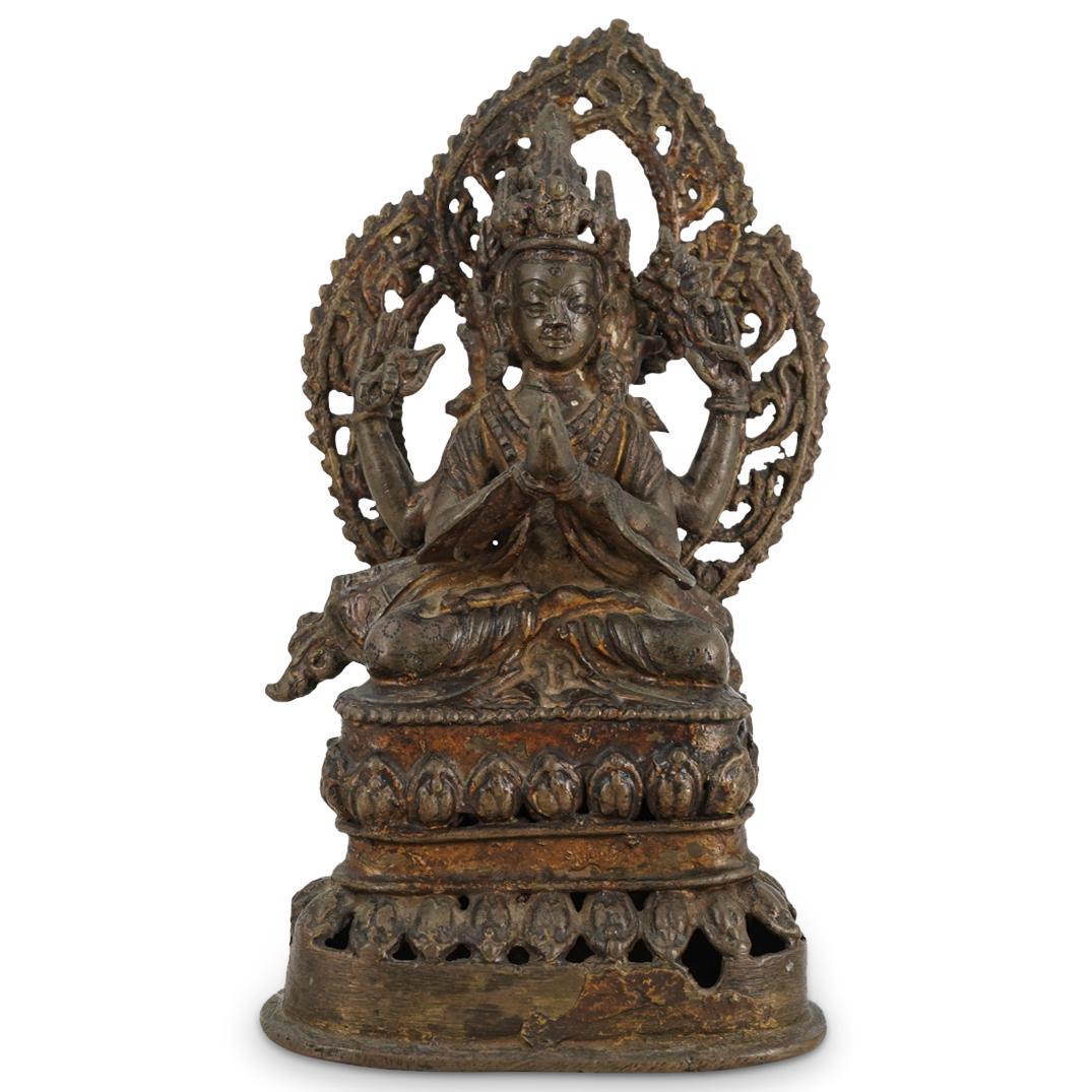 Antique Cambodian Bronze Lokesvara Sculpture: DESCRIPTION: Bronze sculpture depicting Lokesvara, the Cambodian form of Avalokitesvara, the bodhisattva of compassion. Figure has four arms: two front are in the veneration gesture, rear right holds 