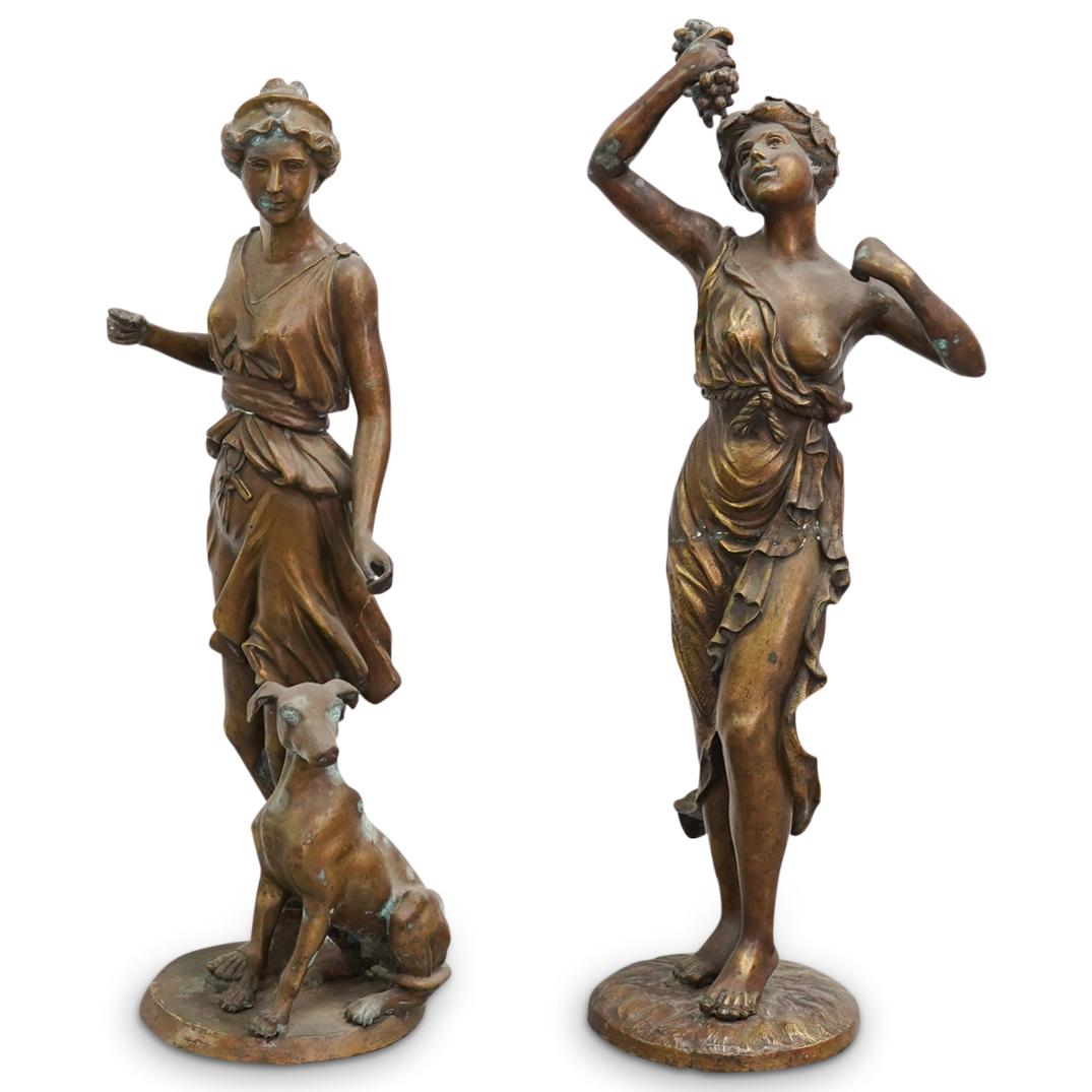 Pair of Antique French Figural Statues: DESCRIPTION: Pair of antique French figural cast metal statues depicting allegorical maidens, features Diana the huntress with dog, and the maiden of wine with grapes. CIRCA: 20th Century ORIGIN: Cont