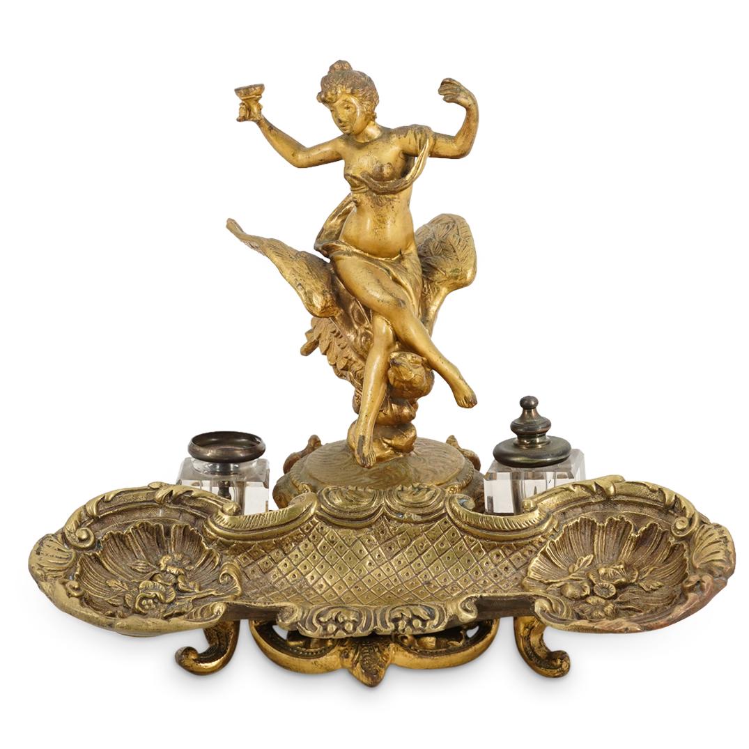 Antique Art Nouveau Gilt Bronze Inkwell & Pen Holder: DESCRIPTION: An antique Art Nouveau gilt bronze inkwell and pen tray features a nude figure atop a bird with spread wings, flanked by double crystal lidded inkwells. CIRCA: 19th Cent. ORIGIN: France D