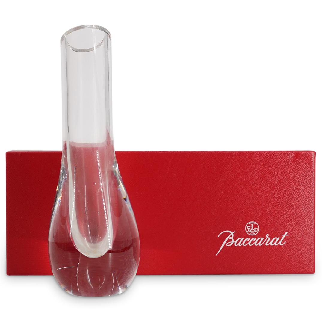 Baccarat Crystal Glass "Albane" Bud Vase W/ Box: DESCRIPTION: Baccarat crystal glass bud vase featuring a smooth design and an angled lip. Marked on underside with Baccarat hallmark. Includes box and paperwork. CIRCA: 20th Century ORIGIN: France DIM
