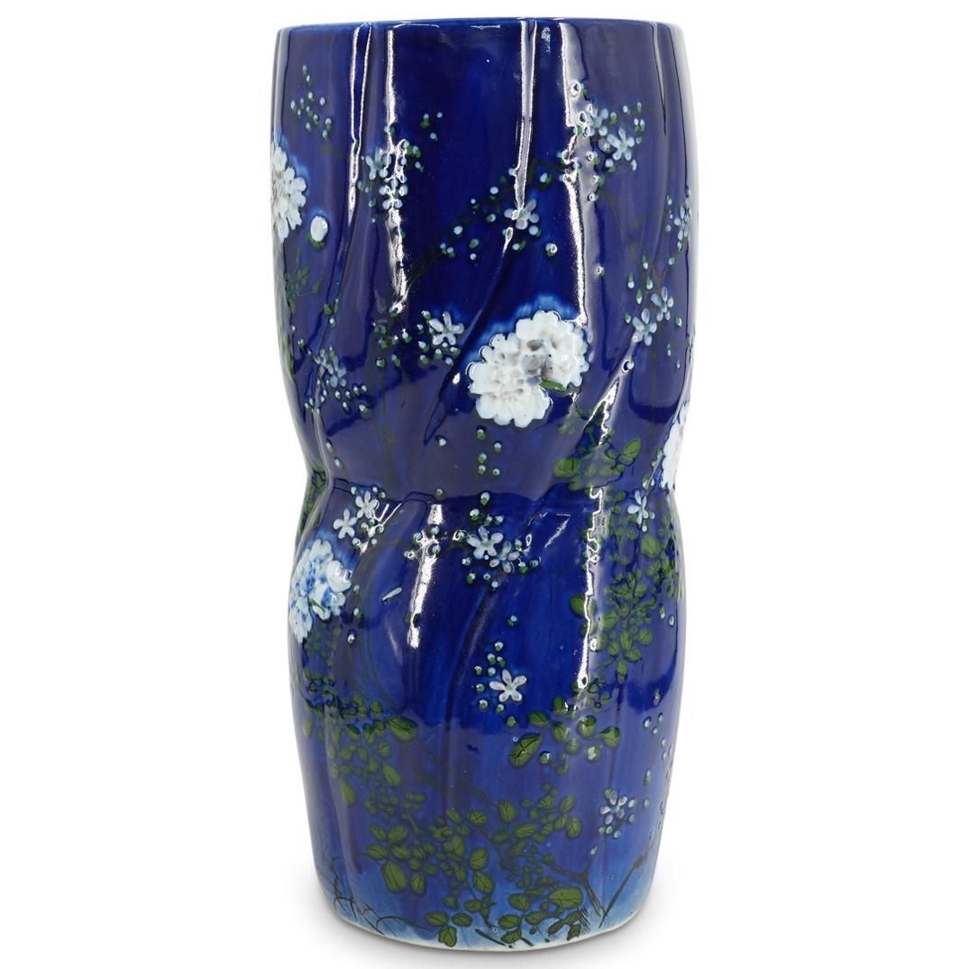Vintage Chinoiserie Porcelain Umbrella Stand: DESCRIPTION: Vintage chinoiserie porcelain umbrella stand featuring floral,m foliage, and bird designs in low relief in a style resembling blue and white porcelain. Piece is decorated with twisted rib