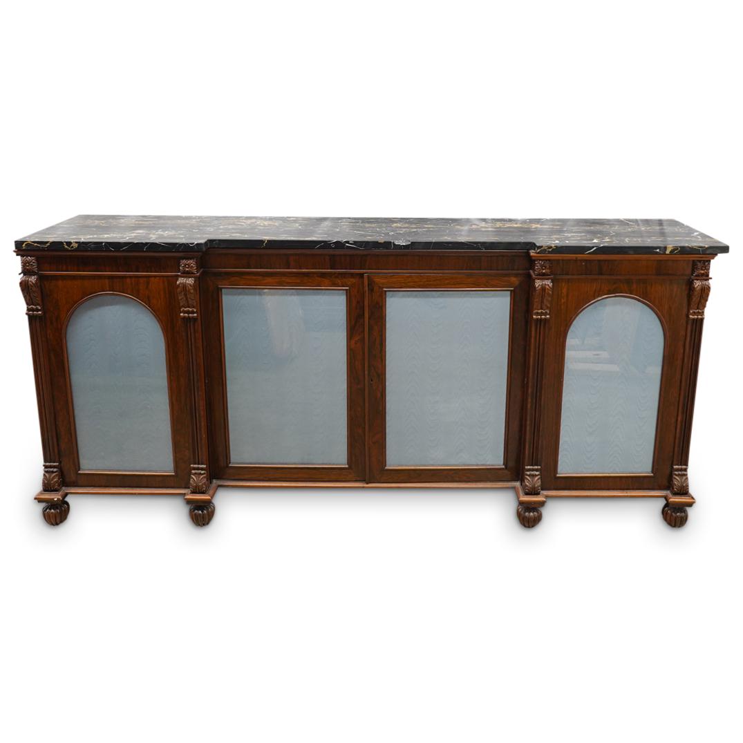 Portero Marble & Wood Console Unit: DESCRIPTION: A Potero marble topped brown wood console unit with frosted arched glass doors, and Neoclassical details. (Isle 1: 003) CIRCA: 20th Century ORIGIN: Continental DIMENSIONS: H: 37.5" x W: 1
