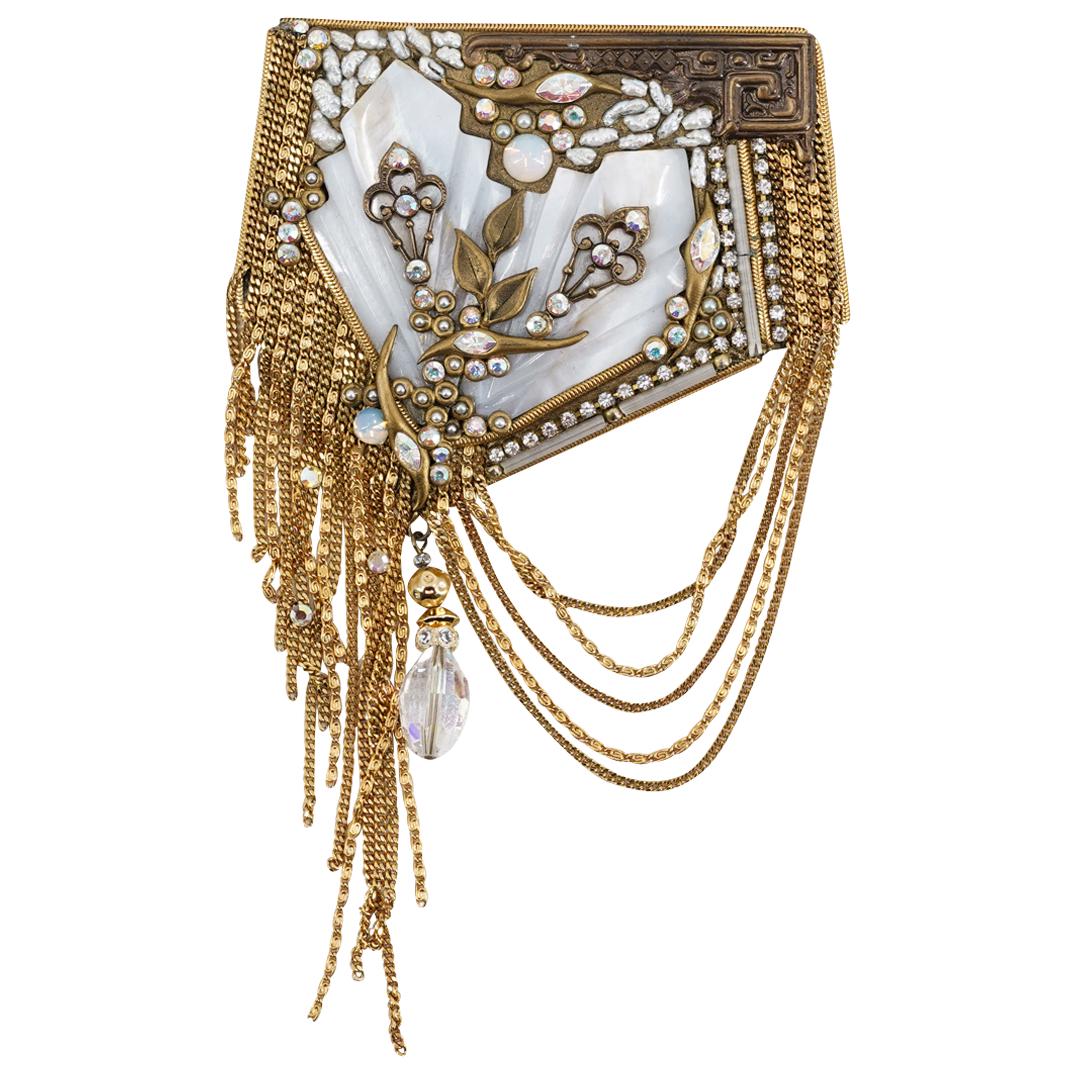 Vintage Marena & Eros Art Deco Style Brooch: DESCRIPTION: Vintage Art Deco style Marena and Eros gilt brooch comprised of strands of gold toned chains, a hanging prism, paved crystals around, inset opalescent glass orbs, abalone at the center an