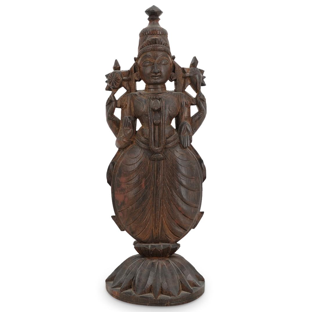 Southeast Asian Carved Wooden Vishnu Sculpture: DESCRIPTION: Southeast Asian carved wooden sculpture depicting the Hindu god, Vishnu, standing atop a lotus throne. Figure's front palms are open, empty, and facing forward; rear arms holding the trum