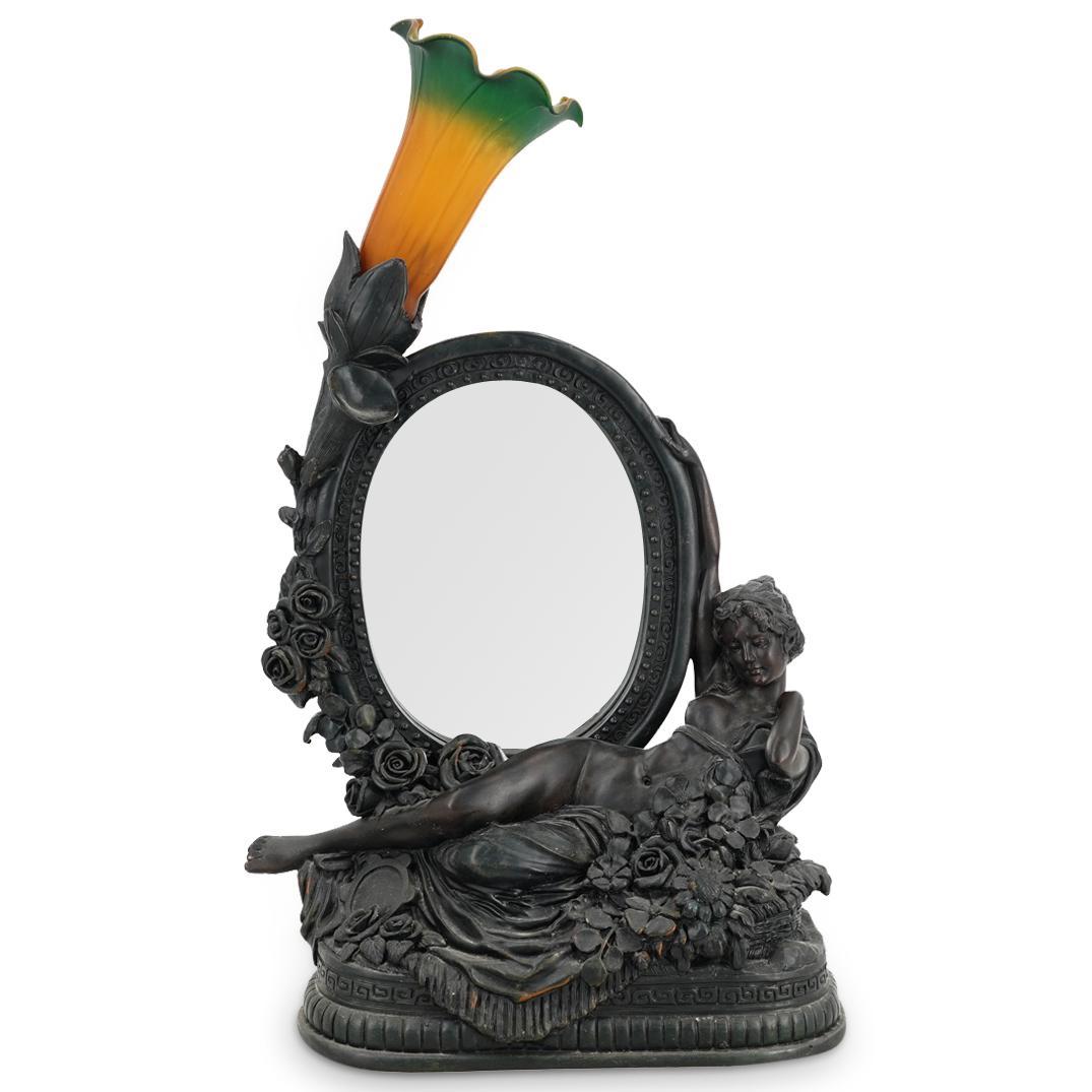 Antique Resin Figural Nude Lamp: DESCRIPTION: Electric single socket table lamp featuring a mirror surrounded by floral and foliage designs and a reclining, nude, female figure among floral, foliage, cloth, and tambourine designs. So