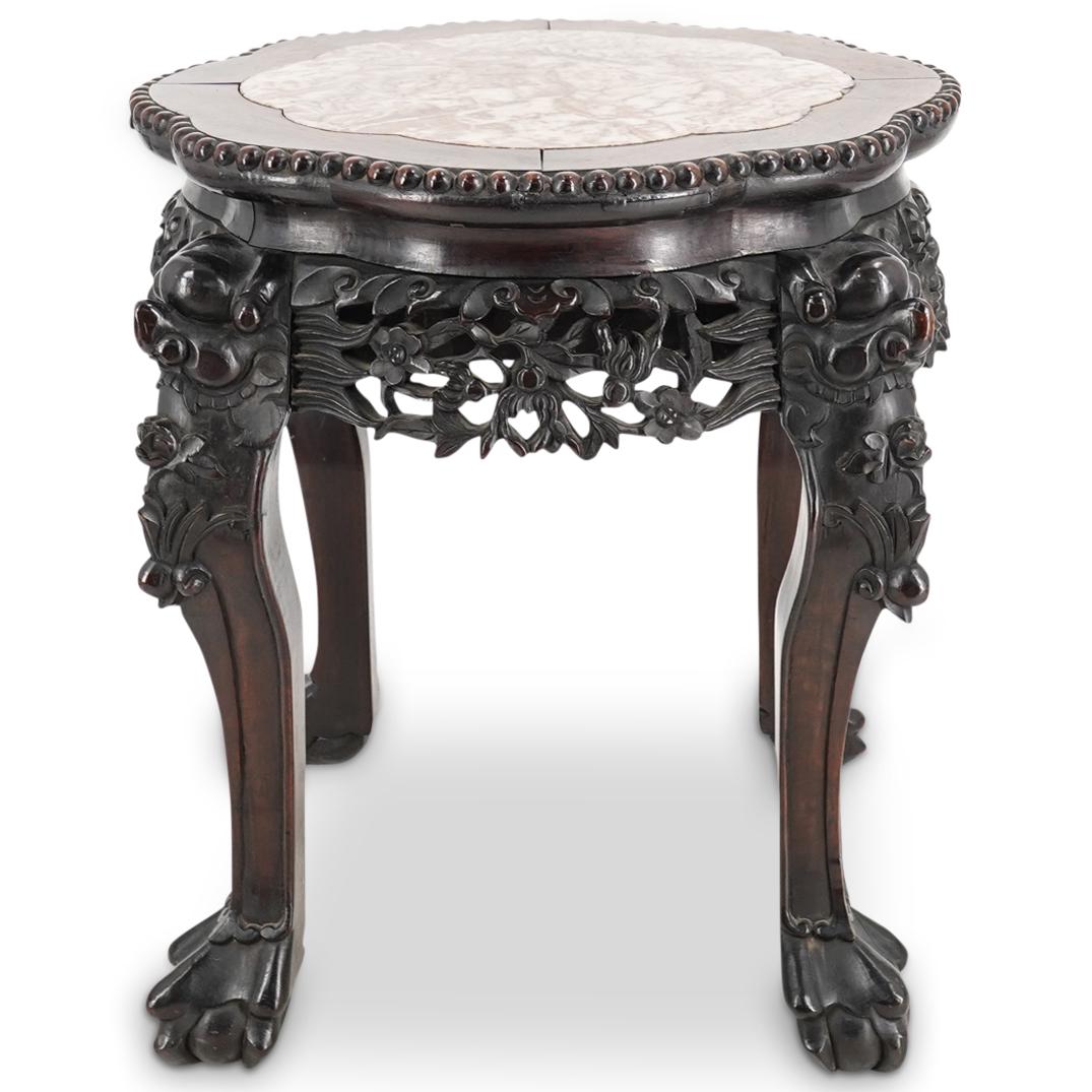 Antique Chinese Carved Wood Pedestal: DESCRIPTION: An antique Chinese wood carved pedestal with center stone inlaid design. Features figural masks with heavy foliate carved details throughout, raised on four claw and ball feet. CIRCA: Ear