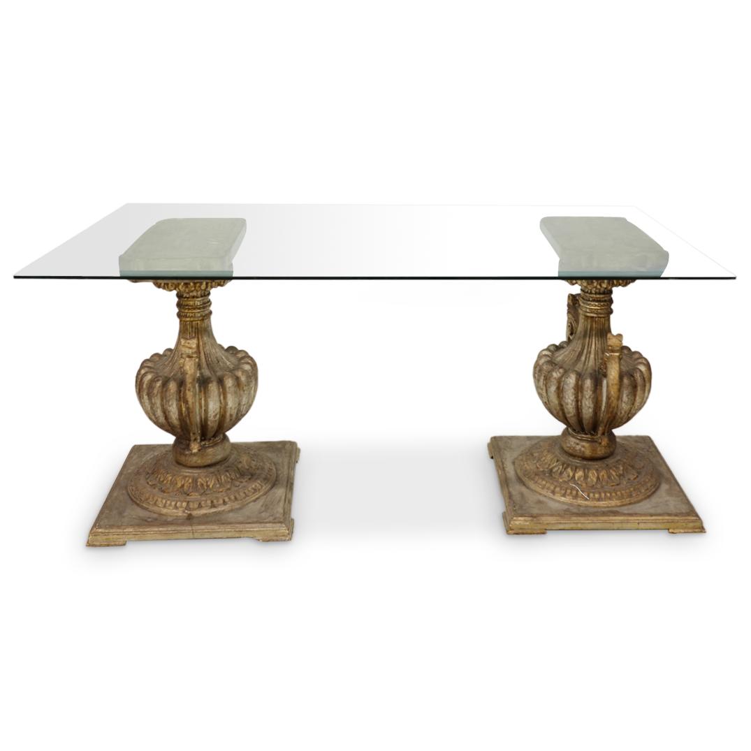 Polychrome Carved Urn Capital & Glass Table: DESCRIPTION: A rectangular beveled glass table raised on two ornate, polychrome urn carved capitals. (A1RB7) CIRCA: Mid 20th Century ORIGIN: Italy DIMENSIONS: (Overall) L: 60" x W: 32" ( Each Base) H:
