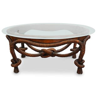 Fine Carved Rope & Tassel Cocktail Table: DESCRIPTION: A carved brown wood rope and tassel formed cocktail table with oval from and beveled glass table top. CIRCA: 20th cent. ORIGIN: France DIMENSIONS: (Table) H: 18" x W: 27.5" x D: 38.5"