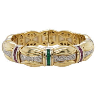 French 18k Gold Diamond and Precious Stone Bracelet: DESCRIPTION: A French 18k two tone yellow and white gold bracelet with a flexible foundation, decorated along the middle with Diamond insets, and further accented with rows of square cut Emerald,