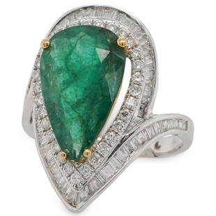 18k Gold, 5ct Emerald & Diamond Ring: DESCRIPTION: 18k white gold ring featuring an oval shaped form garnished by a series of Baguette and sound cut diamonds amounting to approx. 3.5cts, further centered by a 5ct Pear cut Emerald