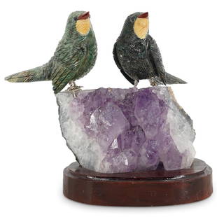 Amethyst and Semi Precious Stone Bird Sculpture: DESCRIPTION: A sculpture featuring two carved birds comprised of Jasper, Chrysocolla and other stones, fitted atop a Amethyst quartz crystal specimen, further fitted atop a wooden base. CIRCA: 21st