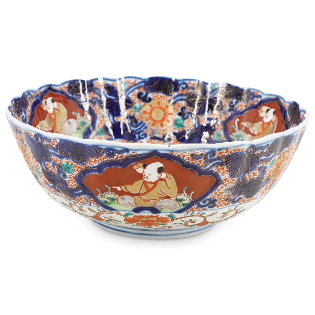 Antique Japanese Imari Porcelain Bowl: DESCRIPTION: Antique Imari porcelain bowl featuring an image in the center of its well of a fenghuang (Chinese phoenix) among floral and foliage motifs. Piece is decorated around lip with four images,