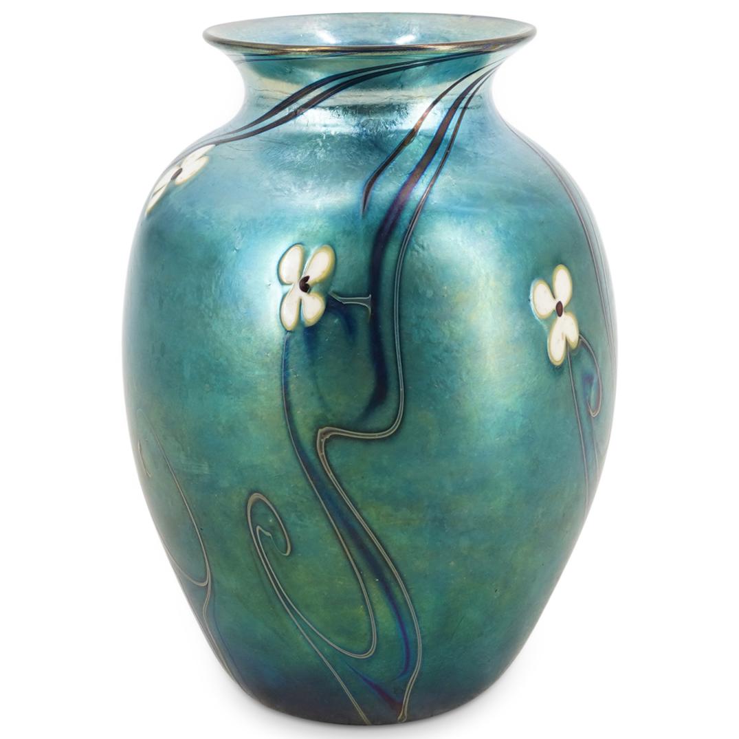 Vintage Orient And Flume Iridescent Art Glass Vase: DESCRIPTION: Art glass vase by Orient and Flume featuring floral and foliage designs throughout against a blue, iridescent ground. Signed "Orient + Flume" and incised "1977" and "156". CIRCA: 20th Cen