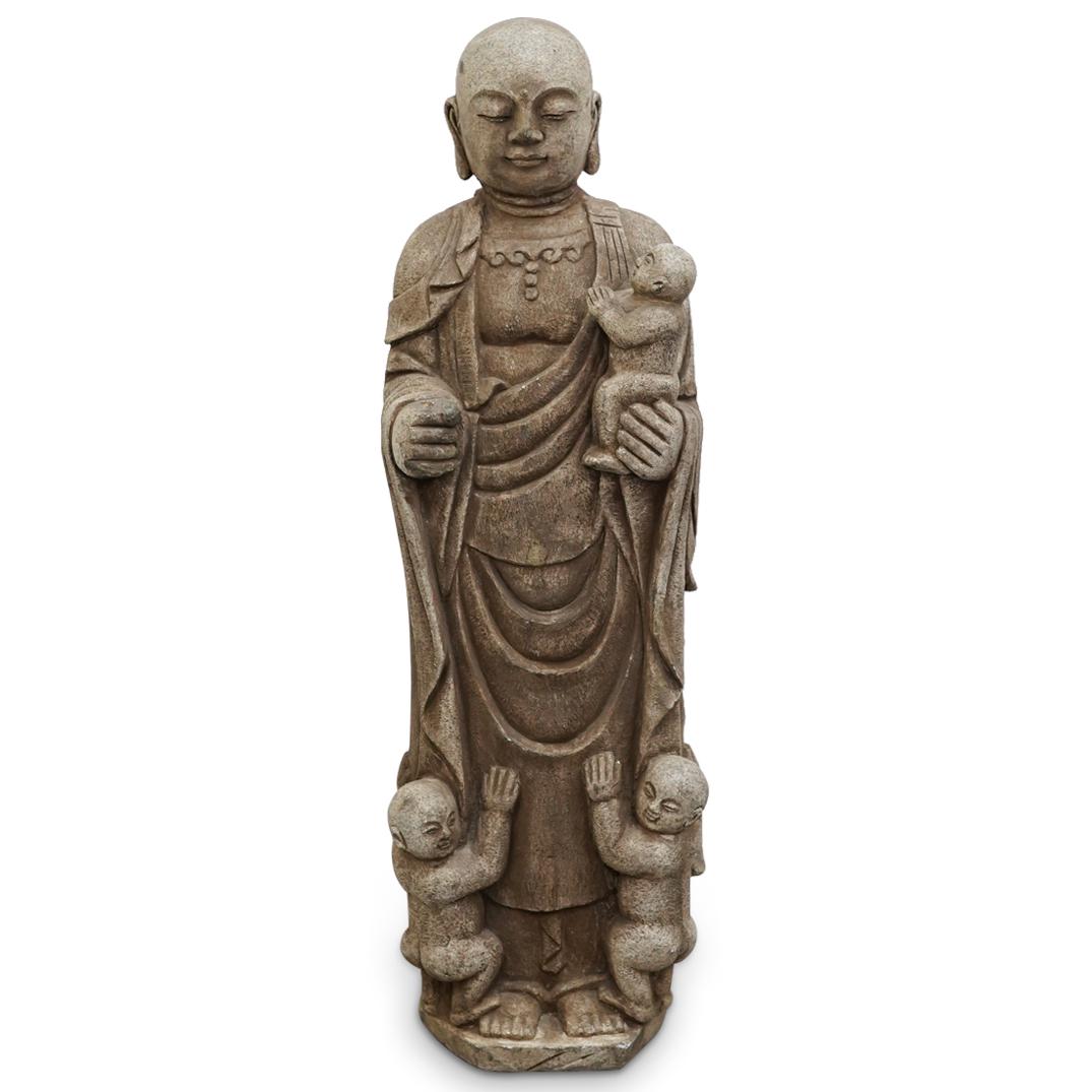 Japanese Stone Jizo Sculpture: DESCRIPTION: Stone sculpture depicting Ksitigarbha ("Jizo"), the bodhisattva of travellers and small children, bearing a staff in his right hand and holding a child in his left hand. Piece is embellis