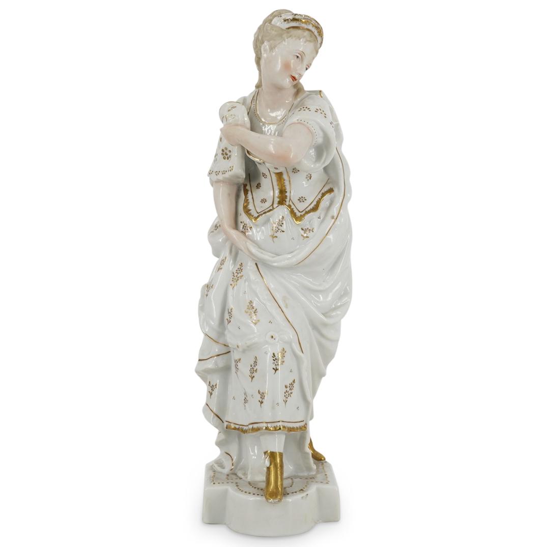 French Porcelain Masquerade Woman Sculpture: DESCRIPTION: Porcelain sculpture depicting a woman in masquerade attire lifting her skirts with her right hand and carrying a mask with her left. Figure's clothing is decorated with gilt floral and fo