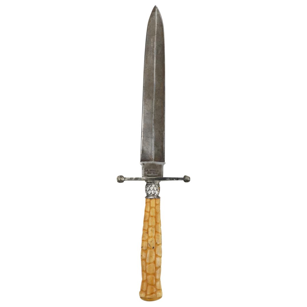 Antique J.D. Chevalier Attr. Dagger: DESCRIPTION: Antique J.D. Chevalier attributed dagger comprising of a double edged blade, diamond form crossguard with spheres at the end, a silver toned metal collar with leaf designs and a carved bo