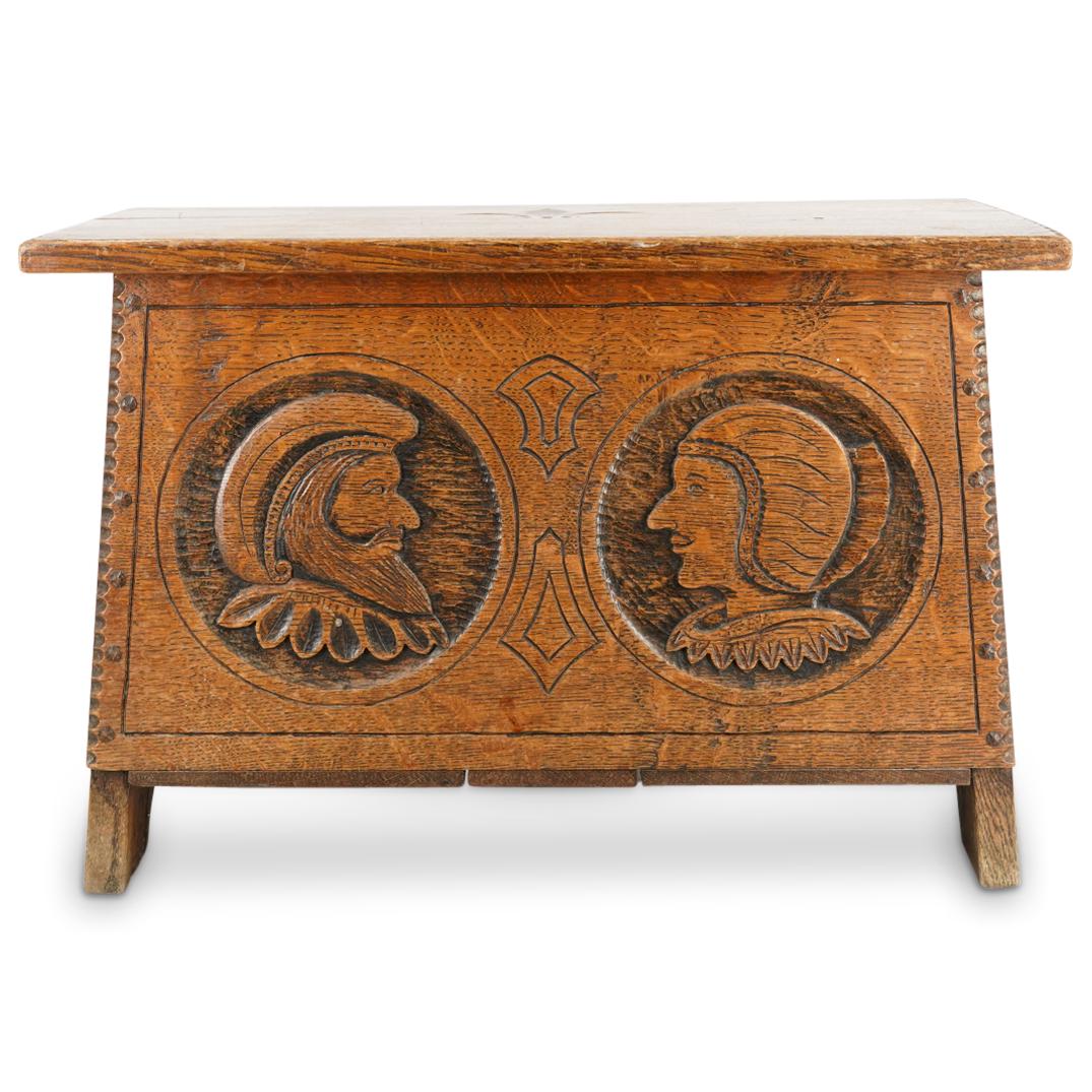 Jack Grimble Cromer Arts & Crafts Wooden Chest: DESCRIPTION: A Wooden Chest in the arts and crafts style, features hand carvings along the front of a colonial male and female, completed with Fleur de lis symbol along the top. Carved underneath the 