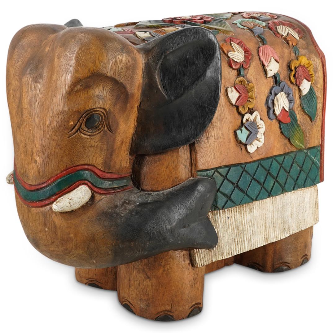 Vintage Indian Carved Wooden Elephant Stool: DESCRIPTION: Carved wooden Asian elephant featuring smooth, rounded edges and painted ears, tusks, toes, nose, and facial accessory. Elephant wears a blanket of one piece with its back decorated with 
