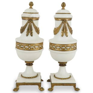 Pair of Ormolu White Marble Cassolettes: DESCRIPTION: A pair of French bronze ormolu and white marble cassolettes with hanging wreath and pierced laurel leaf details. CIRCA: Early 20th Cent. ORIGIN: France DIMENSIONS: H: 11" x D: 5" 