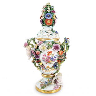 Antique Meissen Porcelain Floral & Foliage Lidded Urn: DESCRIPTION: Meissen porcelain urn featuring a pierced lid and polychrome floral and foliage designs in high relief throughout. Piece is decorated with putto designs, embellished with hand-painted