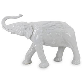 Large Antique Dresden Porcelain Elephant Statue: DESCRIPTION: A large Dresden porcelain depicting an elephant with a raised trunk, decorated with regal saddle, completed with a. white glaze finish. Marked along the underside with Dresden mark. 