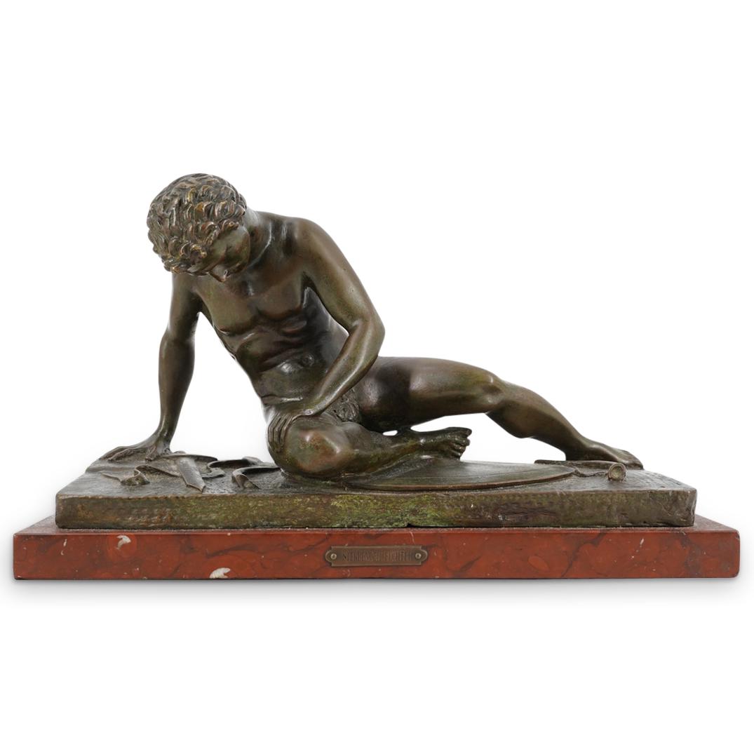 After "Dying Galatian" Sculpture On Rouge Marble Base: DESCRIPTION: Bronze sculpture after the ancient "The Dying Galatian" (a.k.a. "The Dying Gaul") sculpture depicting a felled Galatian dying upon his sword and shield. Piece is mounted on a rouge marble