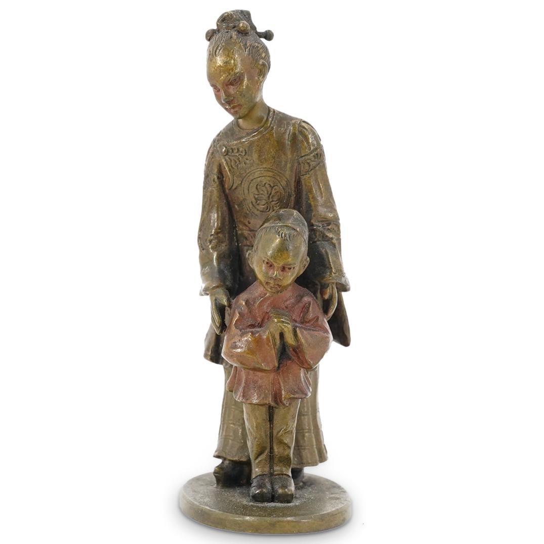 Miniature Viennese Bronze Mother & Child: DESCRIPTION: Miniature Viennese bronze depicting an Oriental mother and child with detail garb and rich brown patina. CIRCA: 19th Cent. ORIGIN: Vienna DIMENSIONS: H: 3.5" x D: 1.75" Have a similar ite